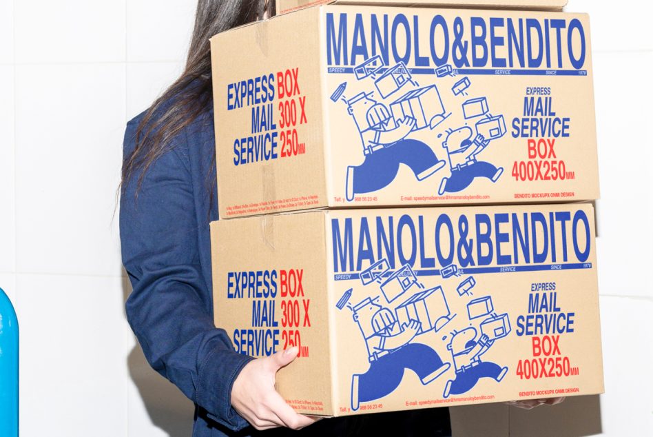 Woman carrying two blue Manolo Bendito cardboard boxes with delivery graphics