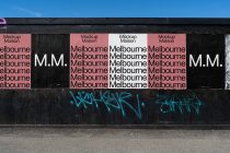 Storefront window with pink, black, white panels showing repeated Melbourne text layout