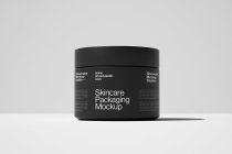 Black cosmetic jar with lid displayed from front angle