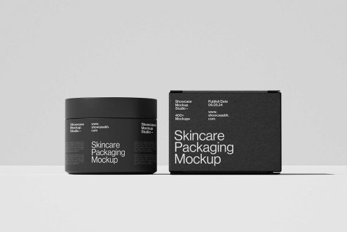 Skincare packaging mockup featuring a black jar and box against a gray background. Ideal for showcasing product design. Categories: Mockups, Graphics, Templates.