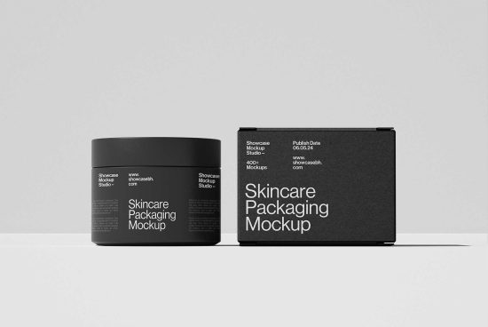 Skincare packaging mockup featuring a black jar and box against a gray background. Ideal for showcasing product design. Categories: Mockups, Graphics, Templates.