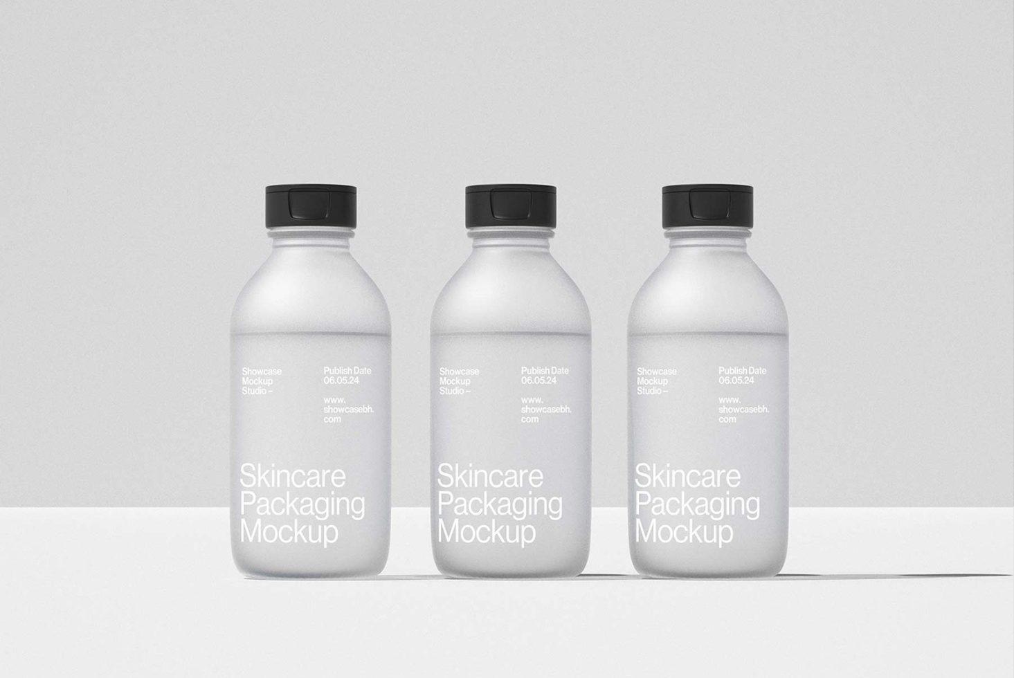 Three minimalistic skincare packaging mockup bottles shown side by side. Ideal for designers in search of clean, professional mockup templates.