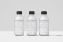Three clear bottles with black caps arranged for cosmetic packaging template display