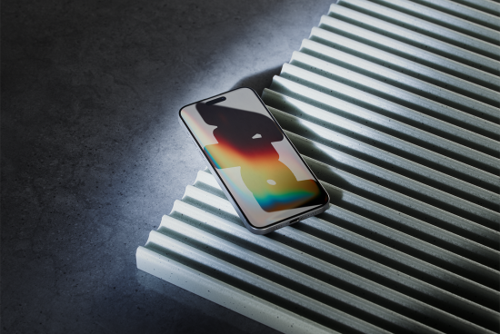 Modern smartphone mockup with colorful light on the screen placed on ribbed surface ideal for digital assets for designers, mockups category, product showcasing