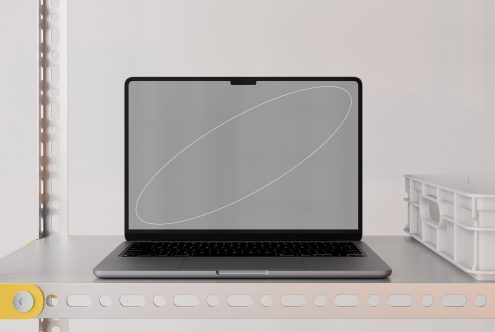 Laptop screen mockup on metal shelf in modern workspace with minimal design elements ideal for digital assets, mockups, templates, web design, and graphic use