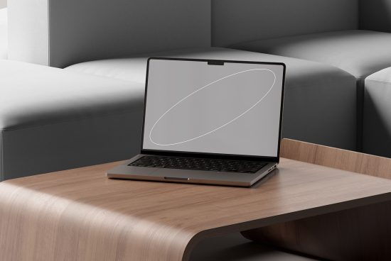 Laptop mockup on wooden table with gray couch background perfect for designers to showcase their digital assets, templates, graphics in a realistic setting.