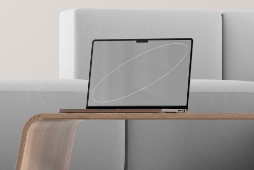 Laptop mockup on modern wooden table in minimalistic living room setting, designed for showcasing website interfaces, digital assets, UI mockups, and templates.