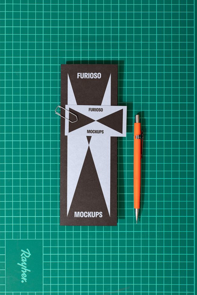 Top view of mockups with black and white geometric designs on green cutting mat with orange pen suitable for digital asset marketplaces targeting designers.