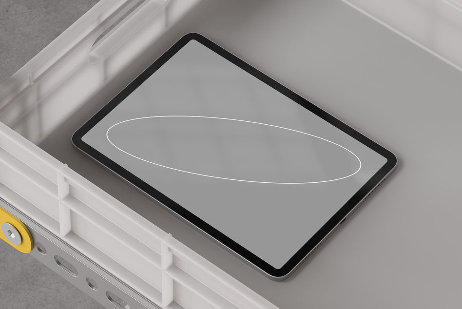 Tablet mockup with blank gray screen sitting in white storage container