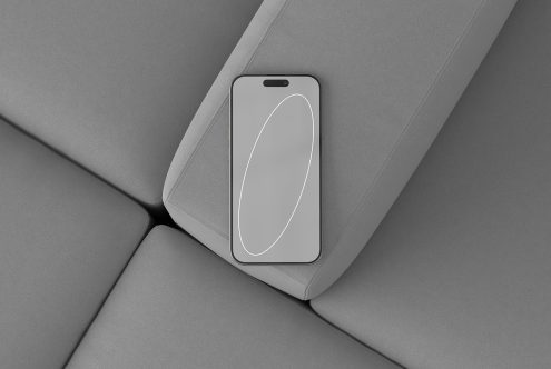 Phone mockup on gray couch showcasing minimalist design top view digital asset for designers ideal for modern graphics templates UI UX projects.