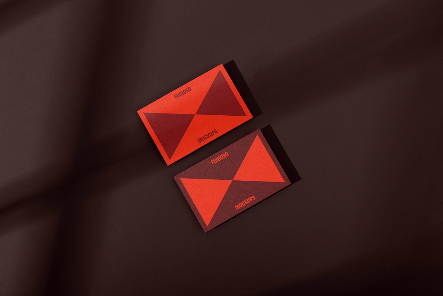 Business card mockups with modern red and dark geometric design on a brown background. Ideal for designers showcasing branding, identity, templates, and graphics.