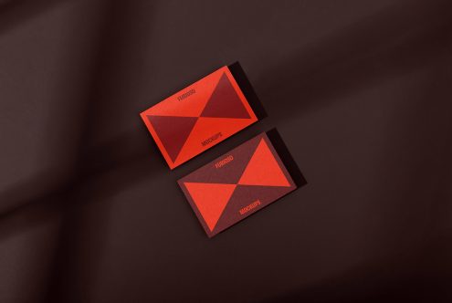 Business card mockups with modern red and dark geometric design on a brown background. Ideal for designers showcasing branding, identity, templates, and graphics.