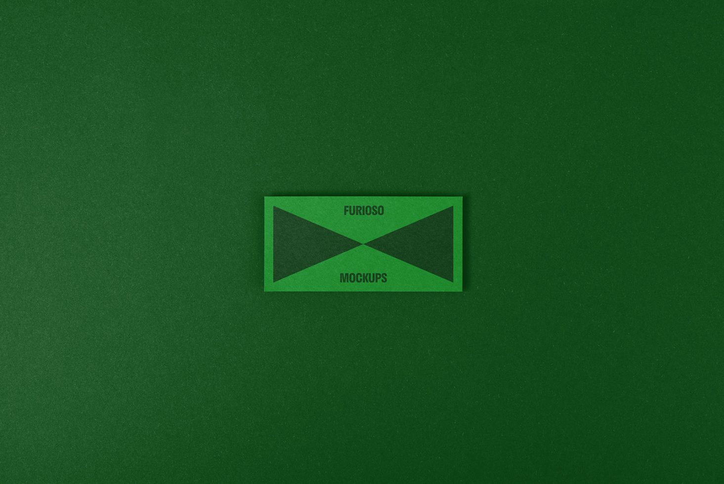 Green textured paper background with a rectangular card saying Furioso Mockups, perfect for branding mockup designs, graphic templates, and creative projects.