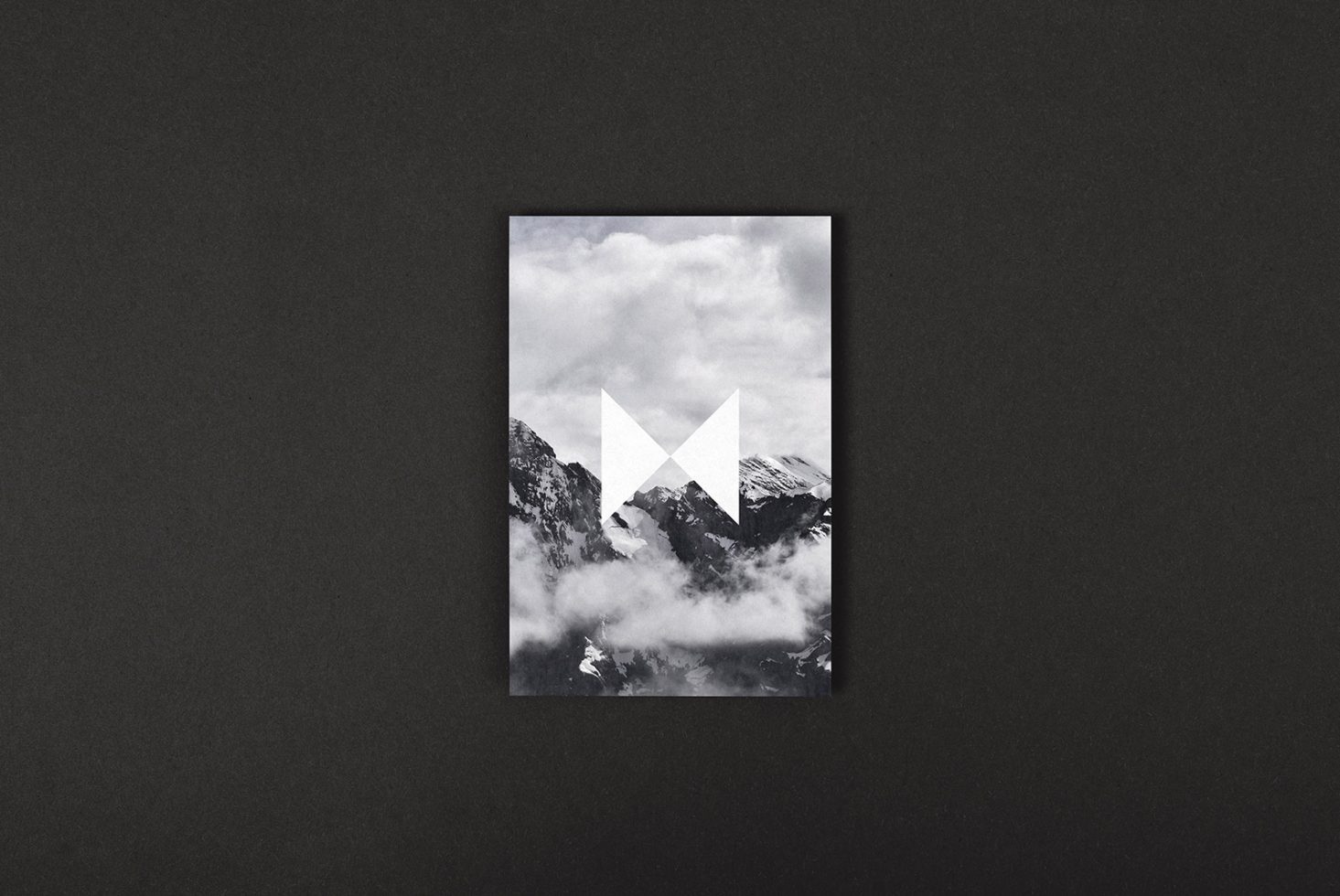 Black and white mountain landscape graphic with an abstract geometric shape overlay placed on a dark background suitable for templates or mockups