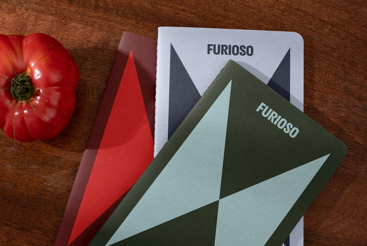 Furioso-themed template with abstract geometric designs, suitable for mockups and graphics. Includes a red tomato on a wood table. Perfect for designers.