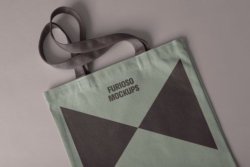 Tote bag mockup with geometric design in grey and green. Perfect for showcasing brand logos and creative designs. Ideal for designers looking for presentation assets.