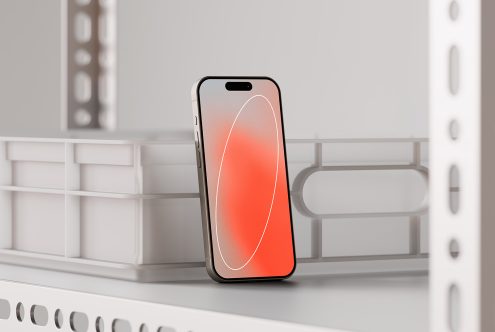 Modern smartphone mockup showcasing a colorful screen, placed on a white shelf in an industrial setting. Perfect for app presentations and digital design.