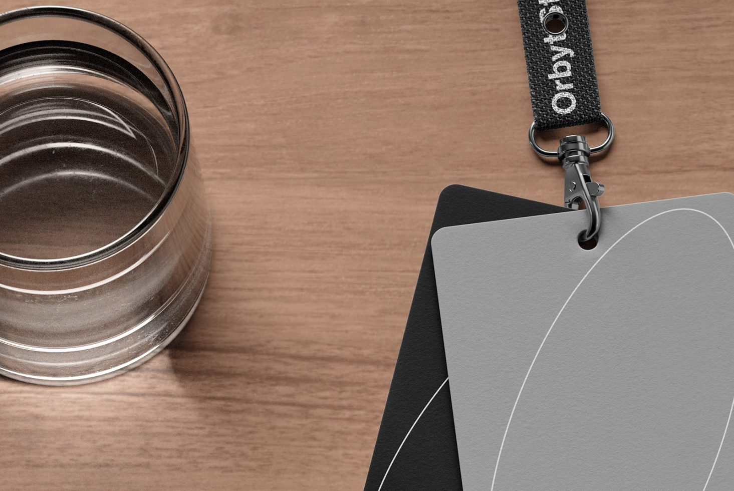 Close-up mockup with glass of water, keychain, and gray swatches on wooden table. Perfect for design presentations, product showcases, and color scheme projects.