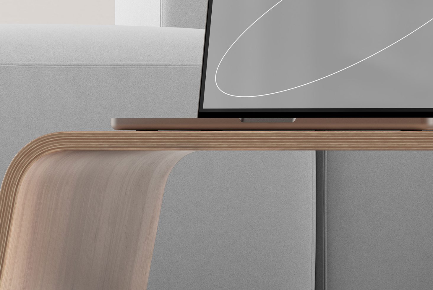 Close-up of sleek minimalist wooden table with modern laptop and gray sofa in background. Ideal for mockups templates furniture design clean aesthetic.