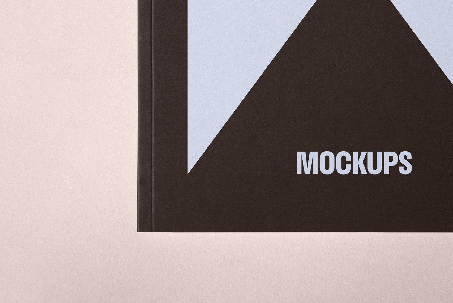 Mockup of a black and grey book cover with the word mockups printed. Ideal for showcasing designs graphic previews and template presentations.