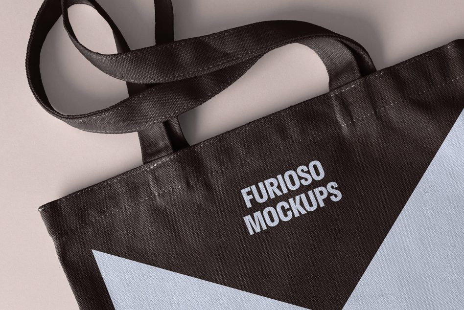 Black tote bag mockup with angled design and text Furioso Mockups great for showcasing branding and logo designs suitable for designers and digital assets