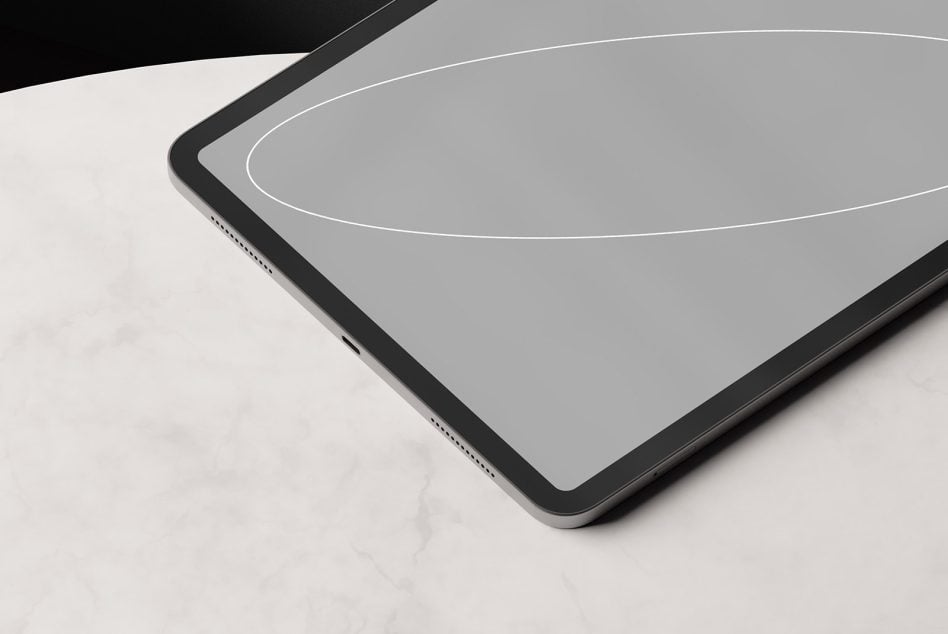 Tablet mockup angled on marble surface with neutral gray screen close-up