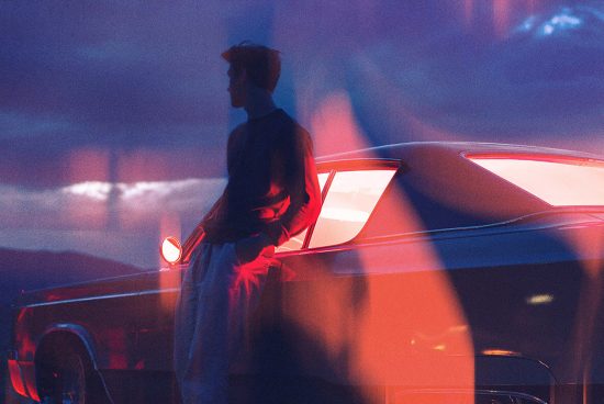 Silhouette of a man leaning against a vintage car at sunset neon lights in the background ideal for graphic templates web designs creative backgrounds