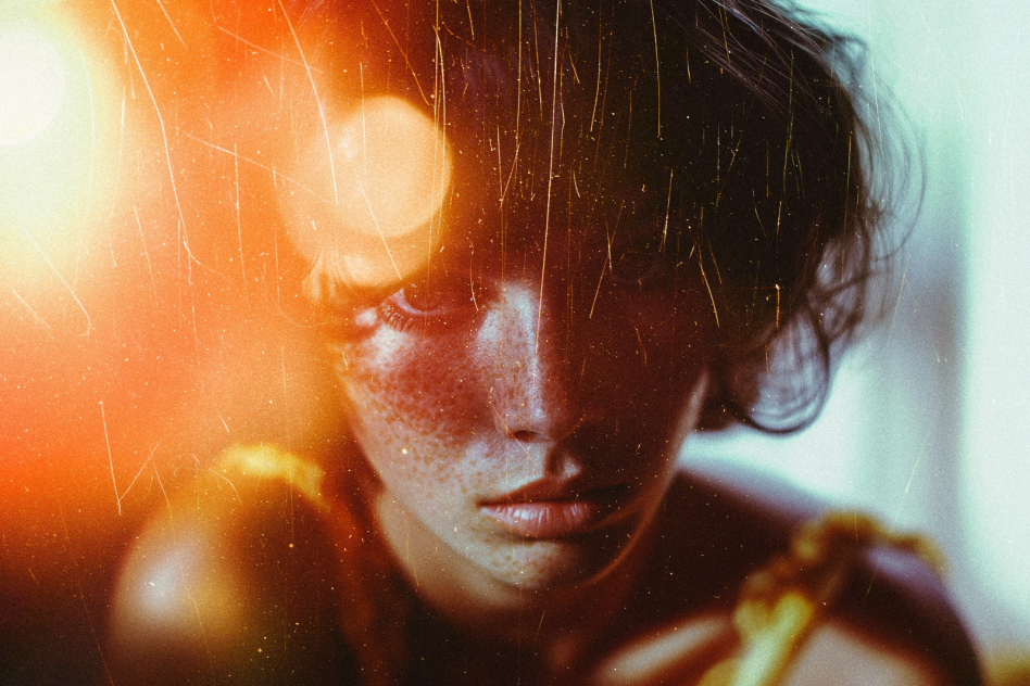 Abstract portrait of a woman with intense lighting effects and grainy texture perfect for creative design projects in graphics mockups and art templates.