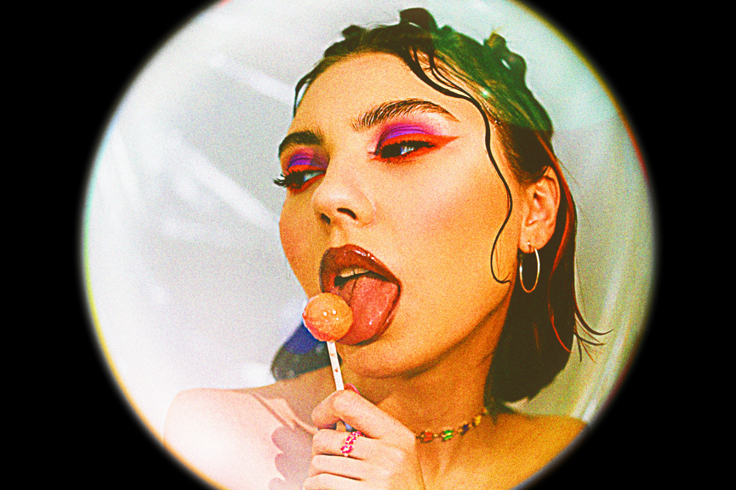 Creative portrait of a young woman with bold makeup and a lollipop vibrant colors and retro style perfect for graphic design projects and art inspiration ideas