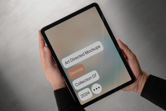 Mockup of a tablet device held in hands featuring a digital design labeled Art Directed Mockups Collection 07 2024 for designers. Ideal for showcasing graphics templates.