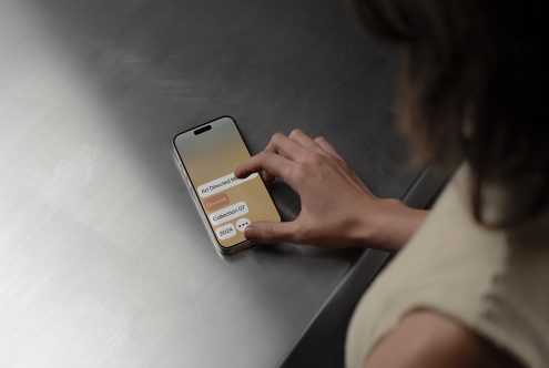 Mockup of a hand tapping an iPhone screen with a sleek design interface; ideal for designers needing phone interface mockups for app or UI presentations.