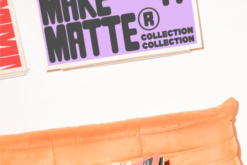 Posters on a wall with bold typography in black and purple Make Matte Collection above an orange cushion. Digital assets for designers, mockups, templates.