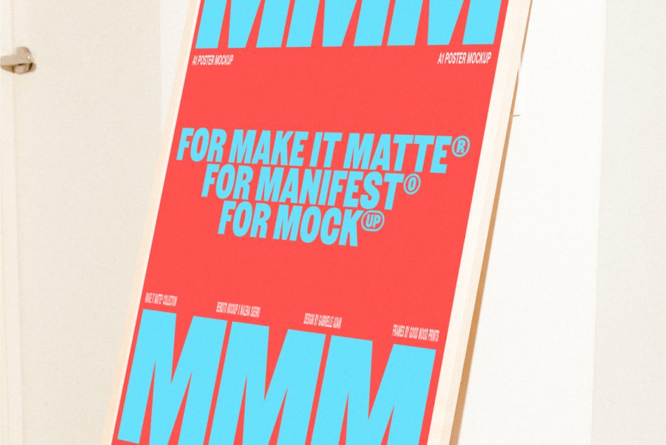 Red poster with cyan letters leaning at angle on wood surface indoors