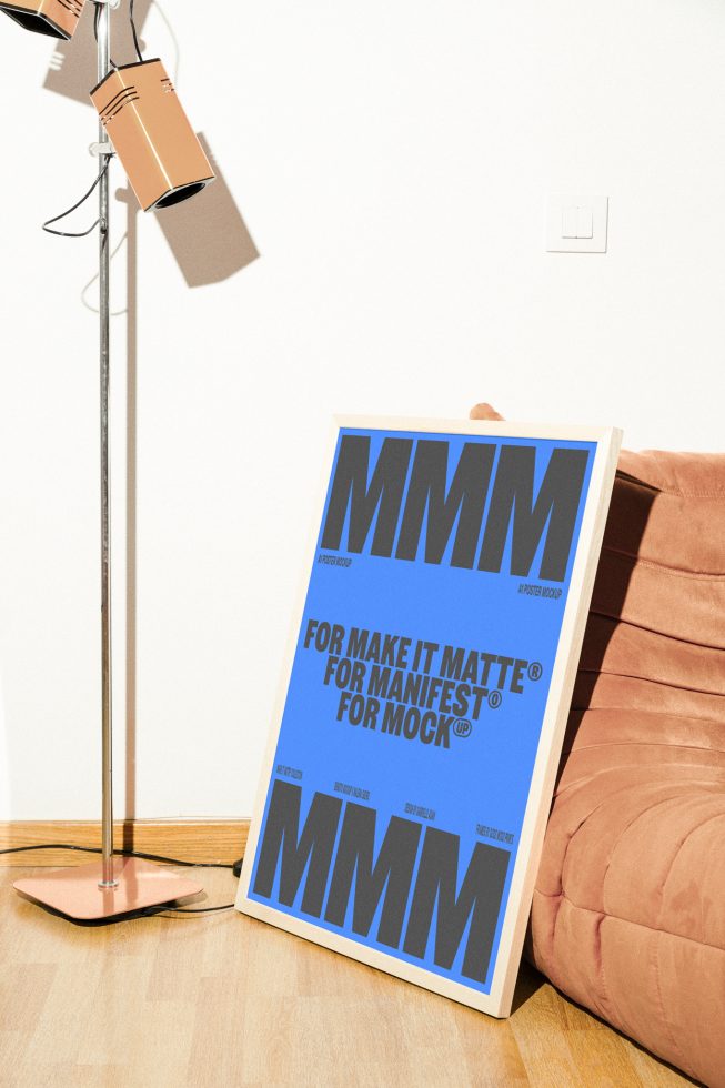 Minimalist poster mockup leaning against a peach couch near a vintage floor lamp, perfect for designers showcasing graphics, templates, or typography.