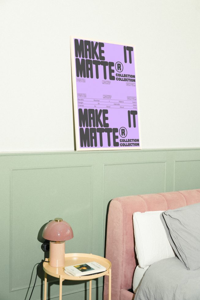 Mockup of a bedroom interior featuring a purple framed poster on a green wall above a pink bed and a beige side table with a lamp and a book. Ideal for designers