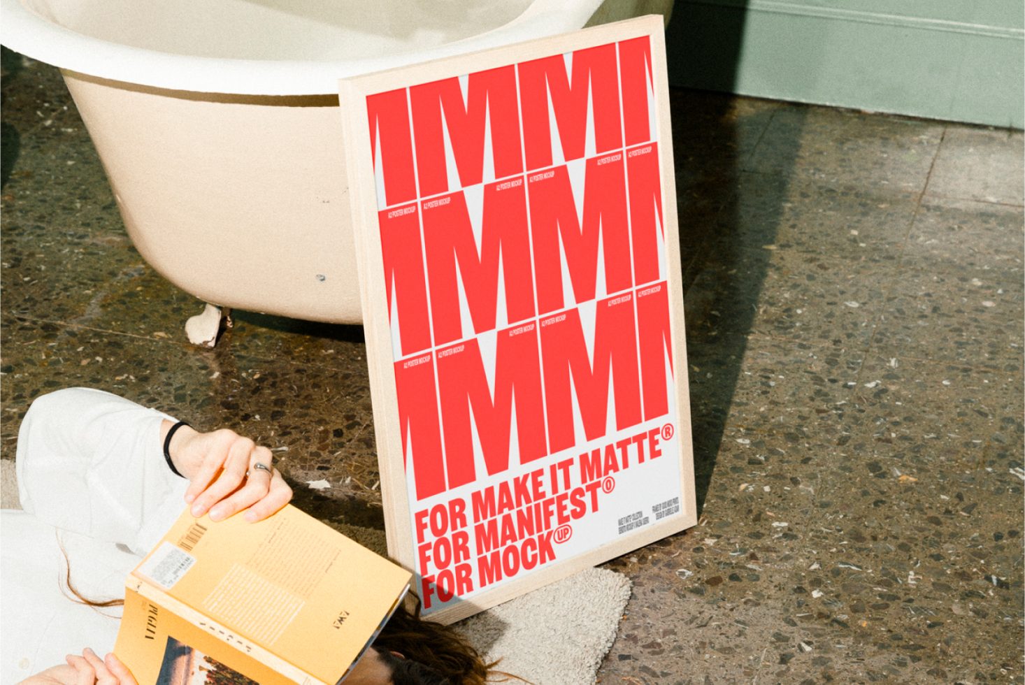 Poster mockup next to a vintage bathtub with a person reading, showcasing a red bold graphic design on a white background. Ideal for designers and mockups.