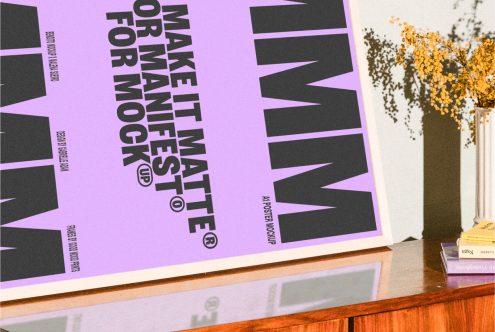 Poster mockup on a wooden desk with violet background and bold black text Make It Matte for Manifest framed art for designers digital asset for mockups templates.