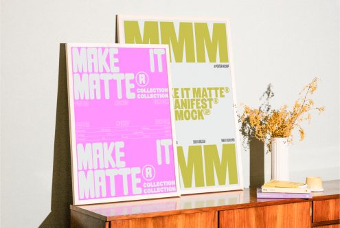 Two poster mockups displayed on a wooden table featuring bold text design with vibrant colors suitable for designers digital assets marketplace mockups templates.