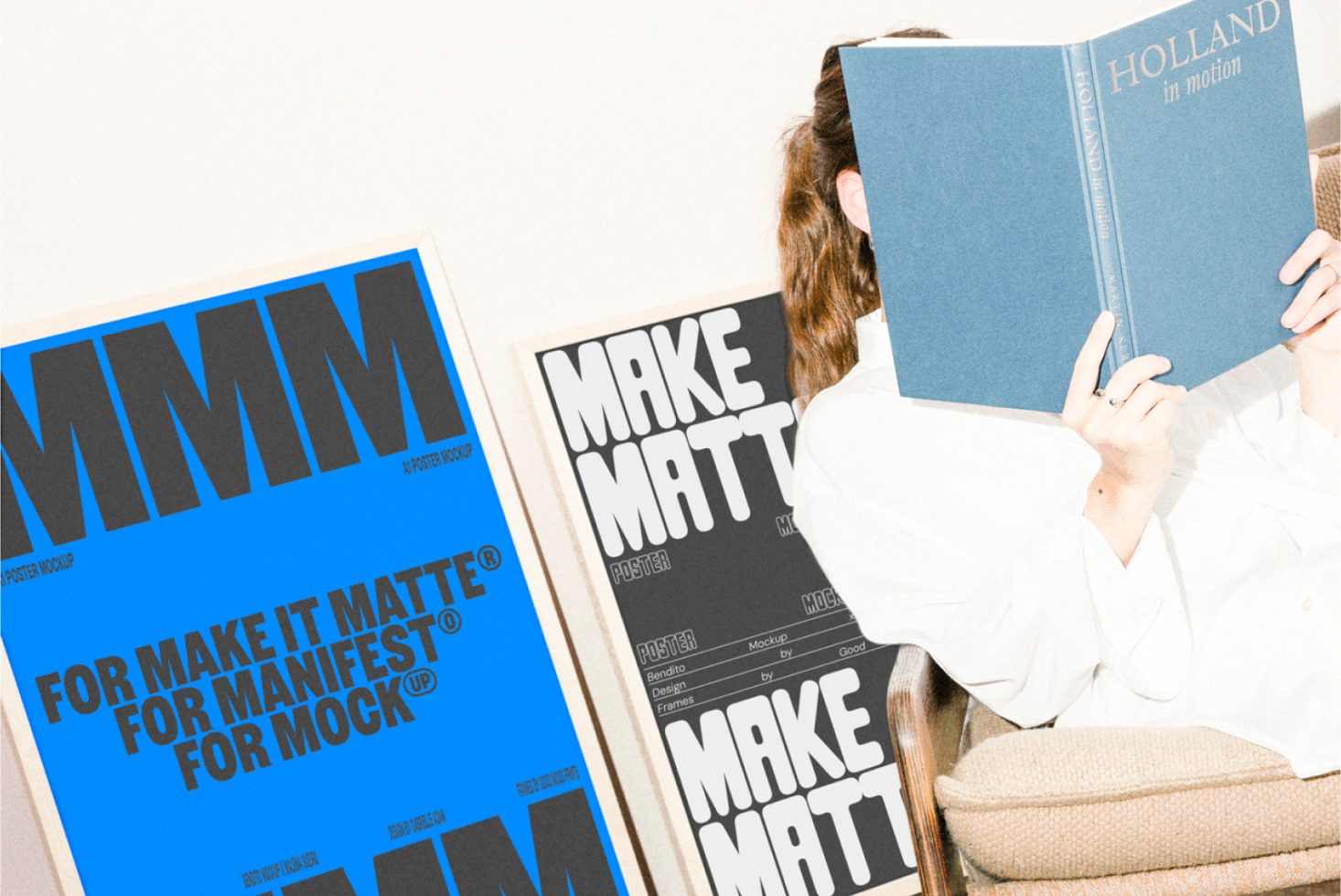 Poster mockup showing blue and black matte designs with bold typography. Person reading a book on a chair in the background. Suitable for graphic designers.