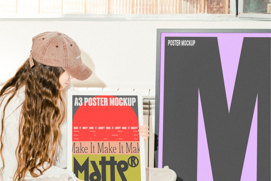 Woman holding red A3 poster mockup next to purple W poster on wall display
