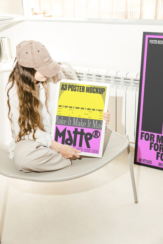 Designer holding an A3 poster mockup with bright yellow and purple colors. Ideal for showcasing digital assets for designers. Keywords: mockup, graphics, templates.