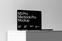 Black M3 Pro Macbook Pro at side angle on white backdrop with shadows