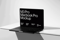 Open black M3 Pro Macbook Pro angled on white geometric platform