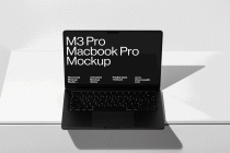 Black M3 Pro Macbook Pro from above on white surface with sharp shadow