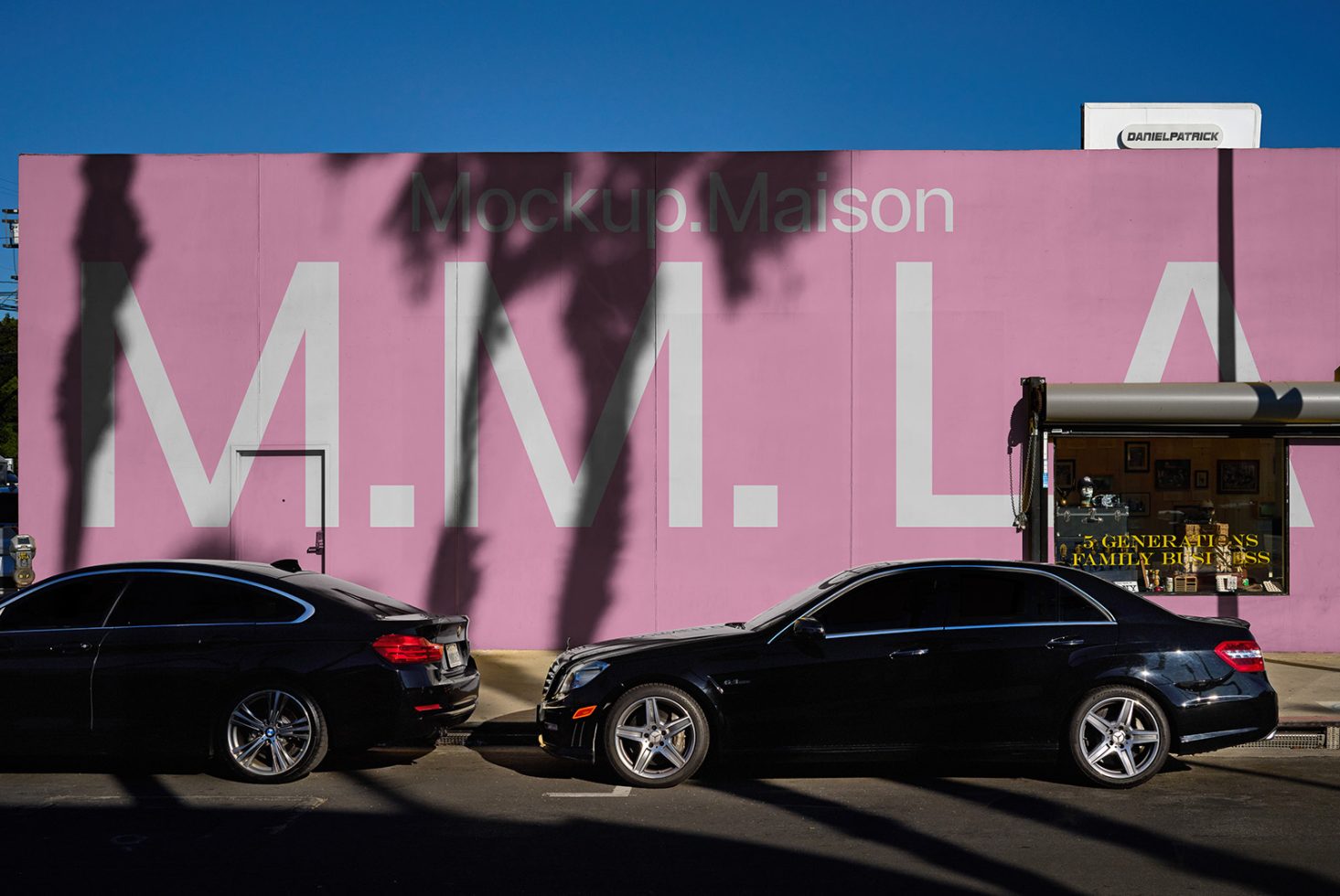 Street view mockup with large pink wall featuring bold white text M M LA ideal for showcasing branding mockups background design SEO keywords mockup wall urban