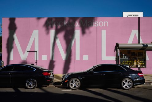 Street view mockup with large pink wall featuring bold white text M M LA ideal for showcasing branding mockups background design SEO keywords mockup wall urban