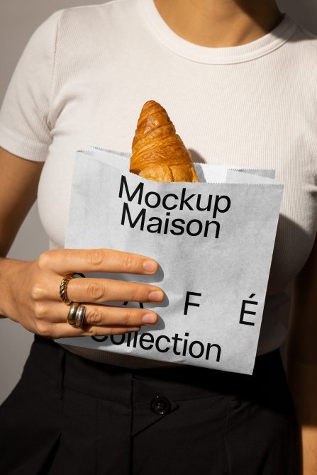 Person holding mockup bag with croissant Keywords: mockup for designers digital assets packaging display branding design template Mockup Maison