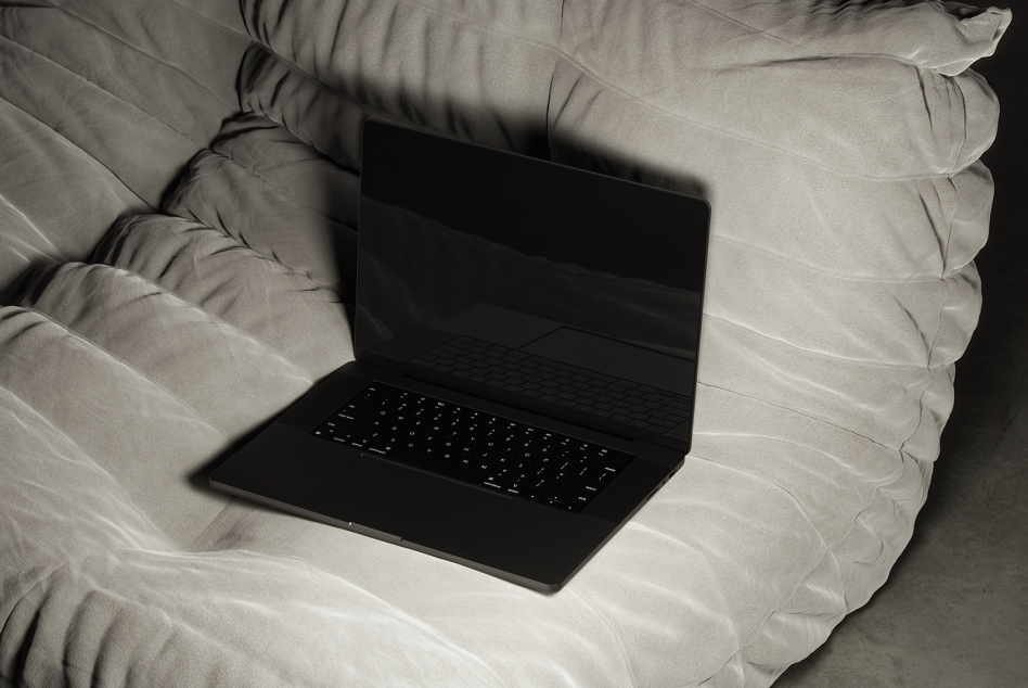 Minimalistic laptop mockup on a cozy gray sofa perfect for presenting website designs app interfaces for digital asset marketplaces and online portfolios