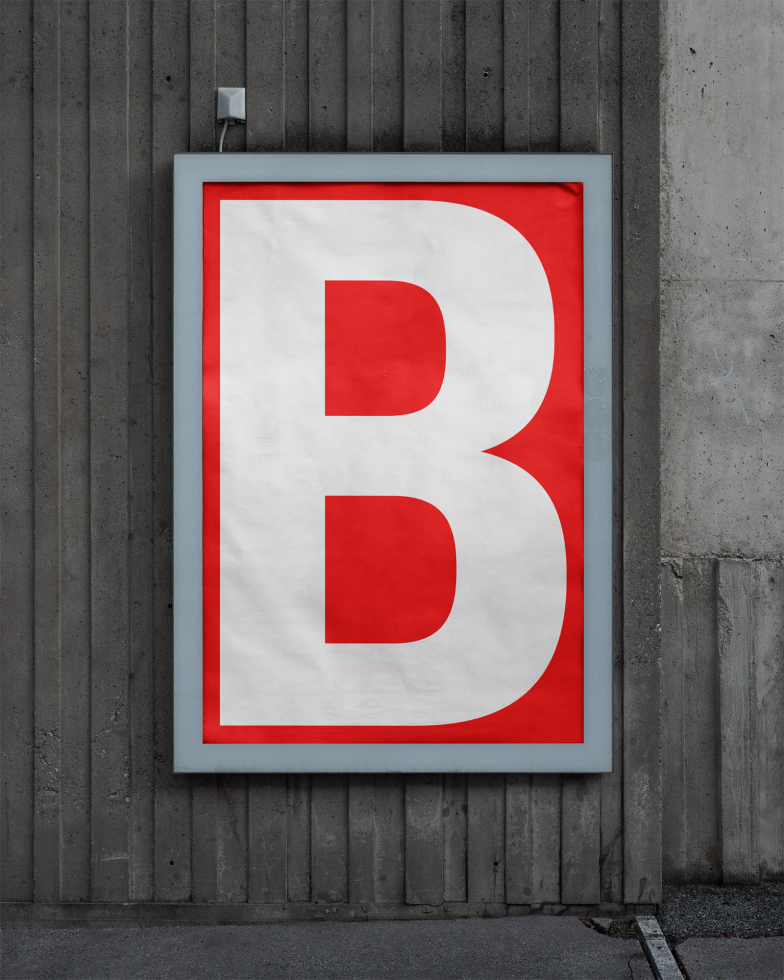 Urban poster mockup with large white letter B on a red background framed by a gray border mounted on a concrete wall. Ideal for graphic design presentations.