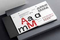 Open book spread showing bold red typography with polka dot cutouts, black geometric shapes, plus alternate character variations in red
